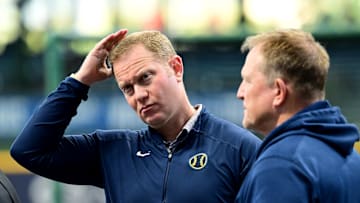 Oct 2, 2024; Milwaukee, Wisconsin, USA; Milwaukee Brewers general manager Matt Arnold talks to manager Matt Arnold before game two of the Wildcard round for the 2024 MLB Playoffs against the New York Mets at American Family Field. Mandatory Credit: Benny Sieu-Imagn Images