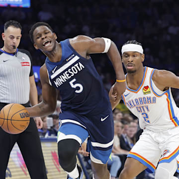 Feb 24, 2025; Oklahoma City, Oklahoma, USA; Minnesota Timberwolves guard Anthony Edwards (5) works to keep the ball inbounds as Oklahoma City Thunder guard Shai Gilgeous-Alexander (2) defends during the second half at Paycom Center. Mandatory Credit: Alonzo Adams-Imagn Images