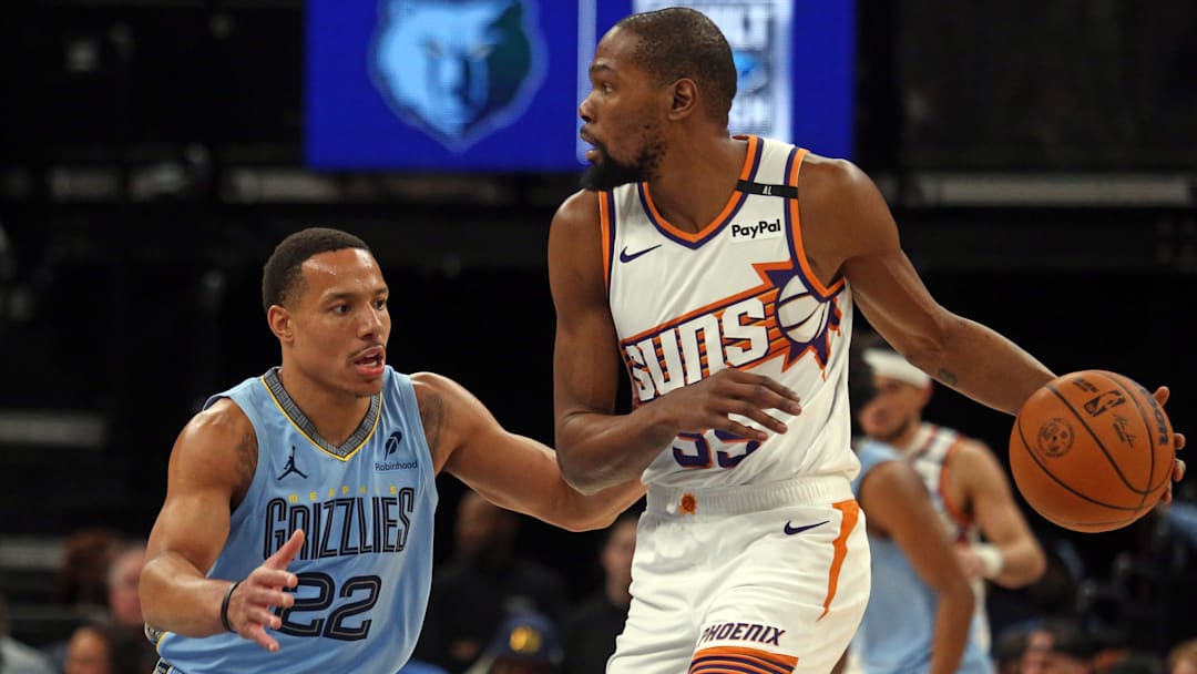 Feb 25, 2025; Memphis, Tennessee, USA; Phoenix Suns forward Kevin Durant (35) handles the ball as Memphis Grizzlies guard Desmond Bane (22) defends during the first quarter at FedExForum. Mandatory Credit: Petre Thomas-Imagn Images