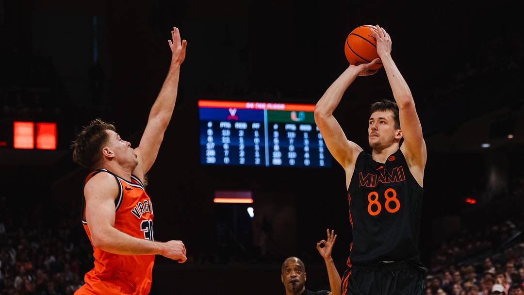 Feb 21, 2026; Charlottesville, Virginia, USA; Miami (FL) Hurricanes forward Timo Malovec (88) shoots the ball while Virginia Cavaliers guard Dallin Hall (30) defends during the first half at John Paul Jones Arena. Mandatory Credit: Emily Faith Morgan-Imagn Images