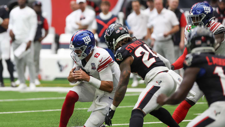 Aug 17, 2024; Houston, Texas, USA;  New York Giants quarterback Daniel Jones (8) scrambles 16 yards and slides against Houston Texans cornerback Derek Stingley Jr. (24) in the first quarter at NRG Stadium.  