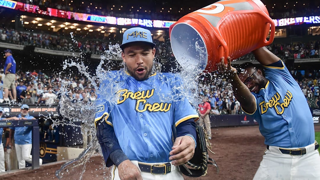 Aug 8, 2025; Milwaukee, Wisconsin, USA; Milwaukee Brewers center fielder Blake Perkins (16) is dunked by shortstop Andruw Monasterio (14) after the Brewers beat the New York Mets at American Family Field. Mandatory Credit: Benny Sieu-Imagn Images
