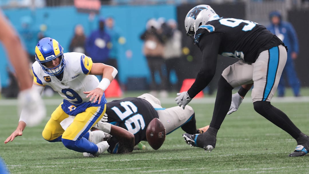 Nov 30, 2025; Charlotte, North Carolina, USA; Los Angeles Rams quarterback Matthew Stafford (9) is sacked by Carolina Panthers defensive end Derrick Brown (95) and fumbles the ball as Carolina Panthers linebacker D.J. Wonnum (98) recovers the football during the fourth quarter at Bank of America Stadium. Mandatory Credit: Scott Kinser-Imagn Images