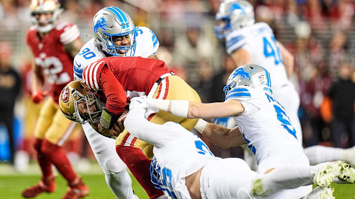 Detroit Lions defensive tackle Chris Smith (90) and defensive end Za'Darius Smith (99) tackle San Francisco 49ers quarterback Brock Purdy (13) during the first half at Levi's Stadium in Santa Clara, Calif. on Monday, Dec. 30, 2024.