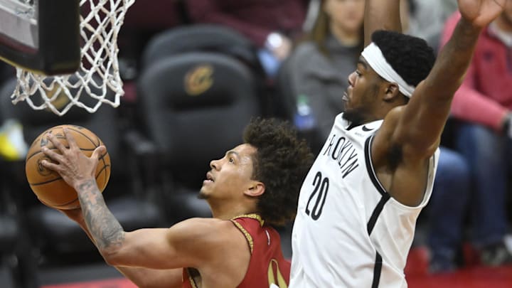 Mar 10, 2024; Cleveland, Ohio, USA; Cleveland Cavaliers guard Craig Porter (9) drives to the basket beside Brooklyn Nets center Day'Ron Sharpe (20) in the fourth quarter at Rocket Mortgage FieldHouse. Mandatory Credit: David Richard-USA TODAY Sports