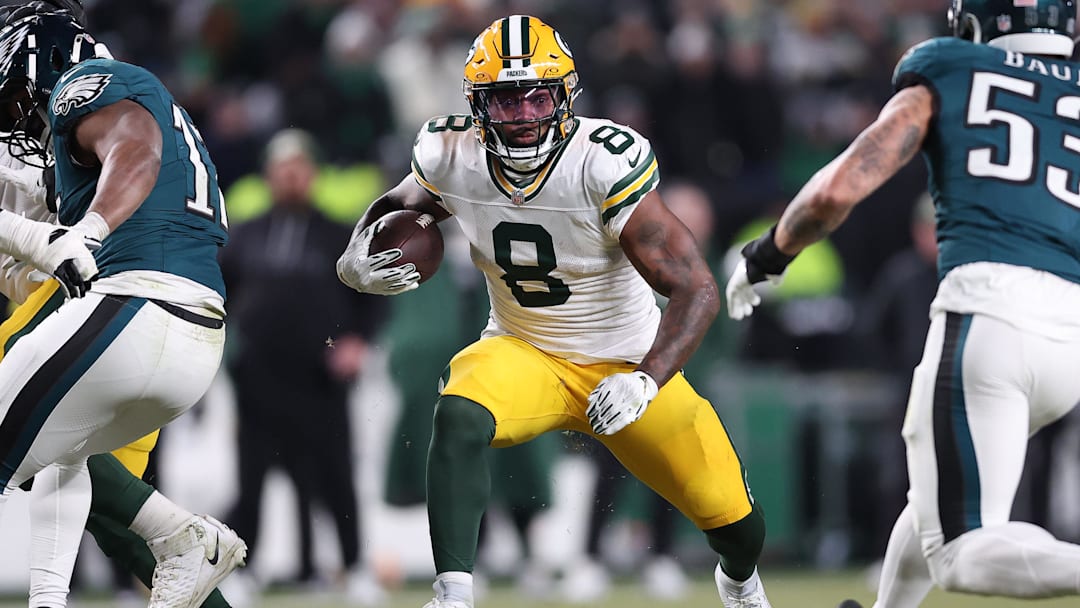 Jan 12, 2025; Philadelphia, Pennsylvania, USA; Green Bay Packers running back Josh Jacobs (8) rushes the ball against the Philadelphia Eagles during the first half in an NFC wild card game at Lincoln Financial Field. Mandatory Credit: Bill Streicher-Imagn Images