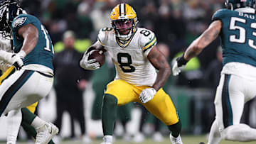Jan 12, 2025; Philadelphia, Pennsylvania, USA; Green Bay Packers running back Josh Jacobs (8) rushes the ball against the Philadelphia Eagles during the first half in an NFC wild card game at Lincoln Financial Field. Mandatory Credit: Bill Streicher-Imagn Images