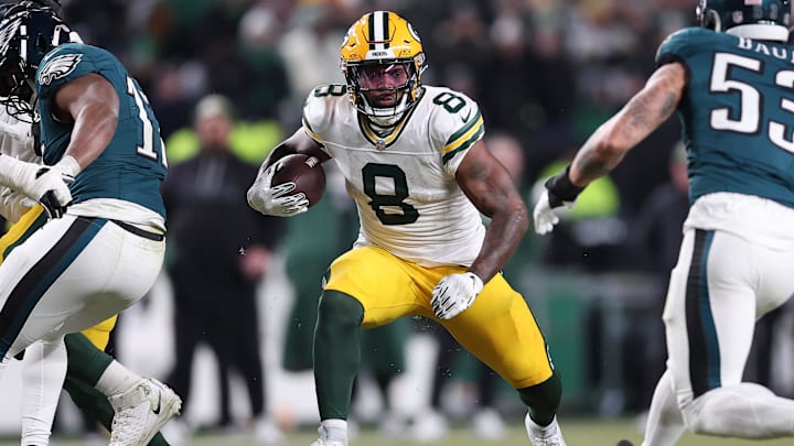 Jan 12, 2025; Philadelphia, Pennsylvania, USA; Green Bay Packers running back Josh Jacobs (8) rushes the ball against the Philadelphia Eagles during the first half in an NFC wild card game at Lincoln Financial Field. Mandatory Credit: Bill Streicher-Imagn Images