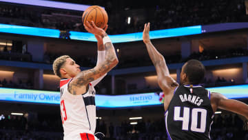 Dec 18, 2023; Sacramento, California, USA; Washington Wizards forward Kyle Kuzma (33) scores a basket against Sacramento Kings forward Harrison Barnes (40) during the third quarter at Golden 1 Center. Mandatory Credit: Kelley L Cox-USA TODAY Sports