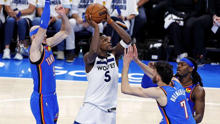 May 28, 2025; Oklahoma City, Oklahoma, USA; Minnesota Timberwolves guard Anthony Edwards (5) drives to the basket against Oklahoma City Thunder guard Alex Caruso (9) during the third quarter in game five of the western conference finals for the 2025 NBA Playoffs at Paycom Center. Mandatory Credit: Alonzo Adams-Imagn Images