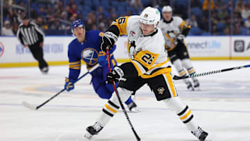Sep 21, 2024; Buffalo, New York, USA;  Pittsburgh Penguins center Tristan Broz (26) takes a shot on goal during the first period against the Buffalo Sabres at KeyBank Center. Mandatory Credit: Timothy T. Ludwig-Imagn Images