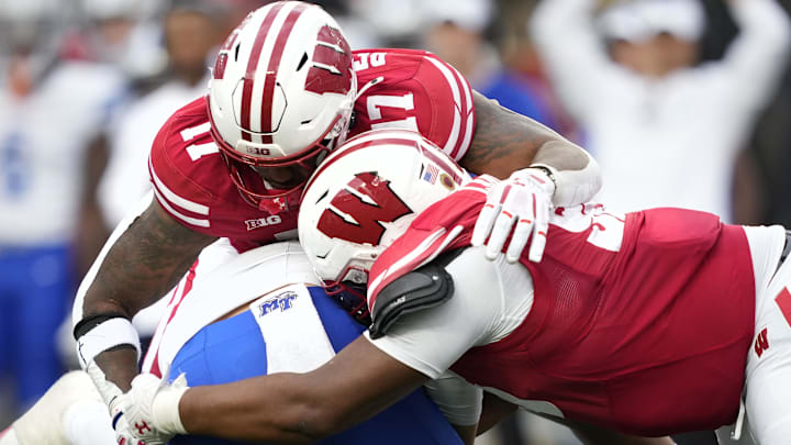 Sep 6, 2025; Madison, Wisconsin, USA; Wisconsin Badgers linebacker Darryl Peterson (17) and Wisconsin Badgers defensive lineman Brandon Lane (95) sack Middle Tennessee Blue Raiders quarterback Nicholas Vattiato (11) during the second half at Camp Randall Stadium. Mandatory Credit: Kayla Wolf-Imagn Images