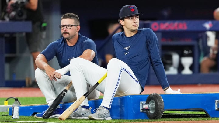 Aug 6, 2024; Toronto, Ontario, CAN; Toronto Blue Jays outfielder Davis Schneider (36) and outfielder Joey Loperfido (9) sit and wait during batting practice before a game against the Baltimore Orioles at Rogers Centre.