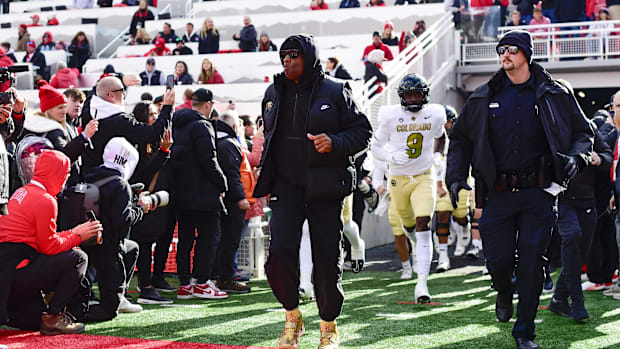 Nov 25, 2023; Salt Lake City, Utah, USA; Colorado Buffaloes head coach Deion 'Coach Prime' Sanders runs out on the field agai