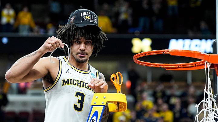 Michigan guard Elliot Cadeau (3) cuts down net to celebrate 95-62 win over Tennessee at the NCAA Tournament Midwest Regional Final at United Center in Chicago on Sunday, March 29, 2026.