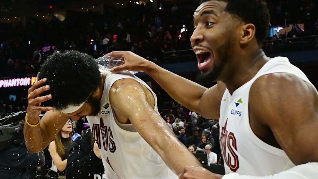 Cleveland Cavaliers guard Donovan Mitchell (45) douses center Jarrett Allen (31) with water
