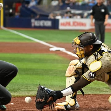 Aug 31, 2024; St. Petersburg, Florida, USA; Tampa Bay Rays first baseman Brandon Lowe (8) slides safe at home as San Diego Padres catcher Kyle Higashioka (20) waits for the ball in the fourth inning  at Tropicana Field. Mandatory Credit: Jonathan Dyer-USA TODAY Sports