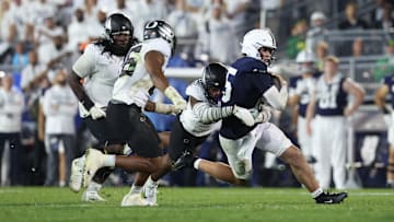  Penn State football quarterback Drew Allar (15) is tackled by Oregon Ducks linebacker Blake Purchase (9) during the fourth quarter at Beaver Stadium