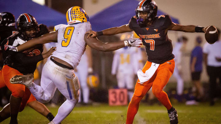 Newberry Panthers Mykah Newton (9) tries to sack \h7u\ in the first half. The Hawthorne Hornets hosted the Newberry Panthers at Hawthorne High School in Hawthorne, FL on Friday, November 17, 2023 in the Class 1R-Region 4 Semifinals. Hawthorne lead 21-0 at the half. [Doug Engle/Ocala Star Banner]