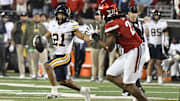 Cal wide receiver Jacob De Jesus tries to elude Louisville defender 