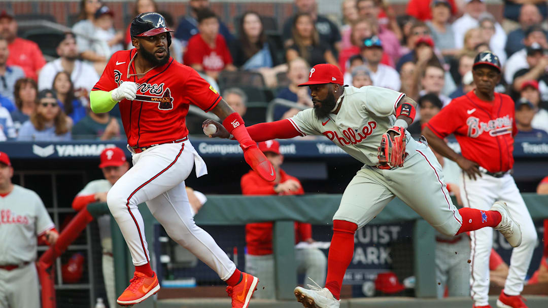 May 26, 2023; Atlanta, Georgia, USA; Atlanta Braves designated hitter Marcell Ozuna (20) is tagged out by Philadelphia Phillies third baseman Josh Harrison (2) in the second inning at Truist Park. Mandatory Credit: Brett Davis-Imagn Images