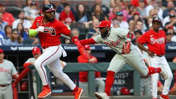 May 26, 2023; Atlanta, Georgia, USA; Atlanta Braves designated hitter Marcell Ozuna (20) is tagged out by Philadelphia Phillies third baseman Josh Harrison (2) in the second inning at Truist Park. Mandatory Credit: Brett Davis-Imagn Images