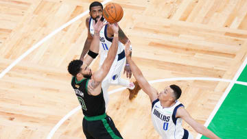 Jun 9, 2024; Boston, Massachusetts, USA; Boston Celtics forward Jayson Tatum (0) shoots against Dallas Mavericks guard Dante Exum (0) in the fourth quarter during game two of the 2024 NBA Finals at TD Garden. Mandatory Credit: David Butler II-USA TODAY Sports