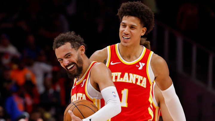 Trae Young and Jalen Johnson enjoy a laugh against the New York Knicks.
