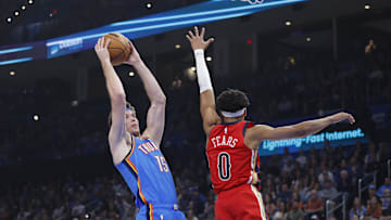 Nov 2, 2025; Oklahoma City, Oklahoma, USA; Oklahoma City Thunder center Branden Carlson (15) goes to the basket as New Orleans Pelicans guard Jeremiah Fears (0) defends during the first quarter at Paycom Center. Mandatory Credit: Alonzo Adams-Imagn Images
