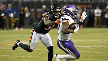 Sep 8, 2025; Chicago, Illinois, USA; Minnesota Vikings running back Jordan Mason (27) rushes the ball against Chicago Bears safety Kevin Byard III (31) during the second half at Soldier Field. Mandatory Credit: Matt Marton-Imagn Images