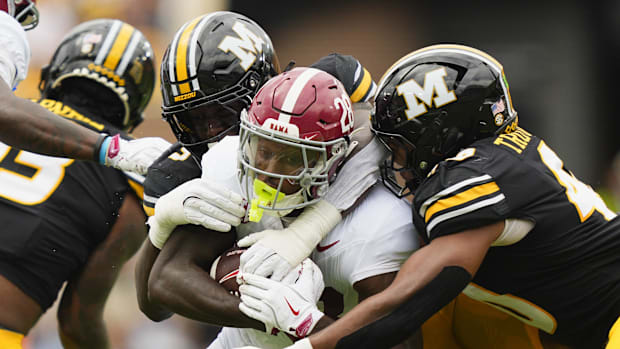 Alabama Crimson Tide running back Kevin Riley (28) is tackled by Missouri Tigers defensive end Zion Young (9.