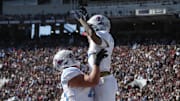 Mississippi Rebels offensive lineman Patrick Kutas (75) and wide receiver Harrison Wallace III (2) celebrate after a touchdown in the first half against the Mississippi State Bulldogs at Davis Wade Stadium at Scott Field. 