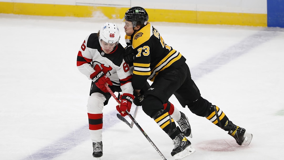 Bruins defenseman Charlie McAvoy (73) taking on Devils forward Jack Hughes (86) in 2021