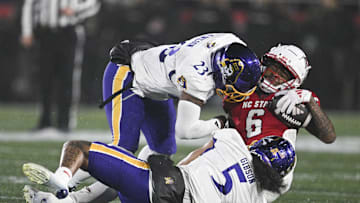 North Carolina State Wolfpack wide receiver Wesley Grimes (6) is hit by East Carolina Pirates linebacker Dameon Wilson (23).