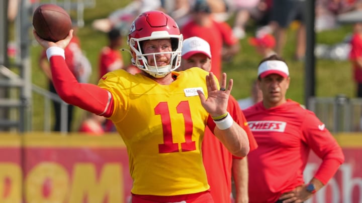 Jul 26, 2024; Kansas City, MO, USA; Kansas City Chiefs Kansas City Chiefs quarterback Carson Wentz (11) throws a pass as general manager Brett Veach watches in the background during training camp at Missouri Western State University. Mandatory Credit: Denny Medley-USA TODAY Sports