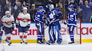 Apr 2, 2025; Toronto, Ontario, CAN; Toronto Maple Leafs forward John Tavares (91) and defenseman Oliver Ekman-Larsson (95) congratulate goaltender Anthony Stolarz (41) after a win against the Florida Panthers at Scotiabank Arena. Mandatory Credit: John E. Sokolowski-Imagn Images