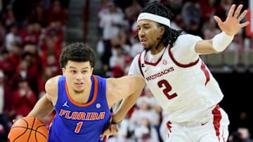 Jan 11, 2025; Fayetteville, Arkansas, USA; Florida Gators guard Walter Clayton Jr. (1) drives against Arkansas Razorbacks guard Boogie Fland (2) during the second half at Bud Walton Arena. Florida won 71-63. Mandatory Credit: Nelson Chenault-Imagn Images