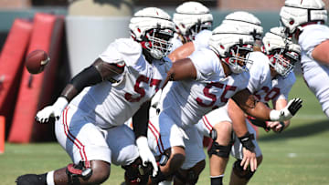 The Crimson Tide players and coaches continue working toward the season opener in practice Tuesday, Aug. 13, 2024. Alabama offensive lineman Elijah Pritchett (57), Alabama offensive lineman Roq Montgomery (55) and Alabama offensive lineman Joseph Ionata (69) move to block.