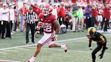 Aug 29, 2024; Little Rock, Arkansas, USA; Arkansas Razorbacks run-in back Ja’Quinden Jackson (22) rushes for a touchdown in the first quarter as Pine Bluff Golden Lions defensive back Zach Williams (34) defends at War Memorial Stadium. Mandatory Credit: Nelson Chenault-USA TODAY Sports