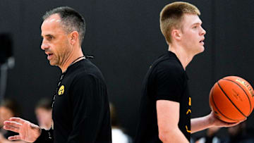 Iowa men’s basketball head coach Ben McCollum passes Bennett Stirtz (14) during practice June 19, 2025 at Carver-Hawkeye Arena in Iowa City, Iowa.
