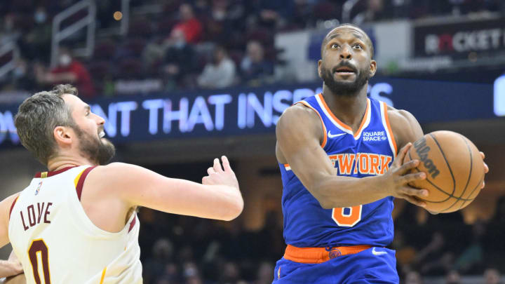 Jan 24, 2022; Cleveland, Ohio, USA; New York Knicks guard Kemba Walker (8) drives to the basket beside Cleveland Cavaliers forward Kevin Love (0) in the second quarter at Rocket Mortgage FieldHouse. Mandatory Credit: David Richard-USA TODAY Sports
