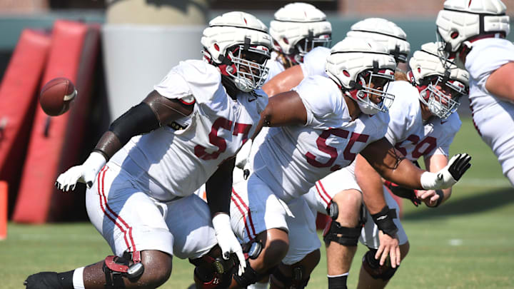 The Crimson Tide players and coaches continue working toward the season opener in practice Tuesday, Aug. 13, 2024. Alabama offensive lineman Elijah Pritchett (57), Alabama offensive lineman Roq Montgomery (55) and Alabama offensive lineman Joseph Ionata (69) move to block.