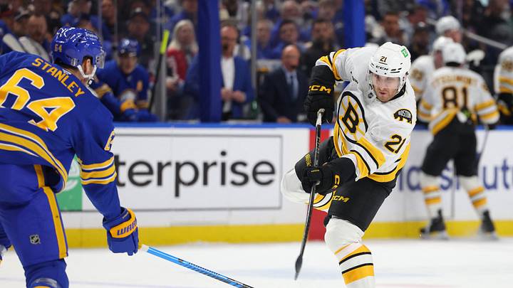 Apr 28, 2026; Buffalo, New York, USA;Buffalo Sabres defenseman Logan Stanley (64) looks to block a shot by Boston Bruins center Alex Steeves (21) during the first period  in game five of the first round of the 2026 Stanley Cup Playoffs at KeyBank Center. Mandatory Credit: Timothy T. Ludwig-Imagn Images