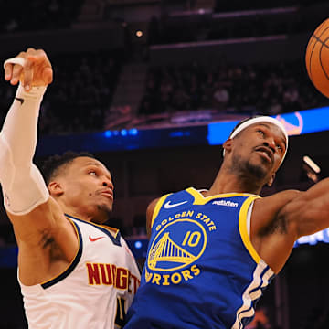 Mar 17, 2025; San Francisco, California, USA; Golden State Warriors forward Jimmy Butler III (10) controls the ball against Denver Nuggets guard Russell Westbrook (4) during the second quarter at Chase Center. Mandatory Credit: Kelley L Cox-Imagn Images