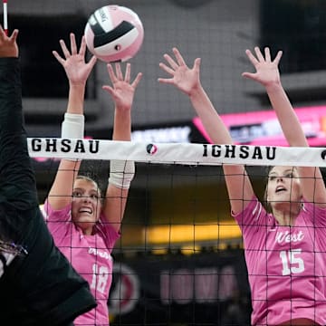 Iowa City West's Josephine Austen (18) and Audrey Small (15) defend an attack by Ankeny Centennial's Adilyne Reyes (11) Nov. 3, 2025 during the Class 5A Iowa high school state volleyball quarterfinals at Xtream Arena in Coralville, Iowa.