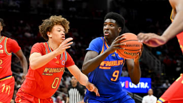 Apr 2, 2024; Houston, TX, USA; McDonald's All American East guard Drake Powell (9) drives to the basket around McDonald's All American West guard Trent Perry (0) during the first half at Toyota Center. Mandatory Credit: Maria Lysaker-USA TODAY Sports