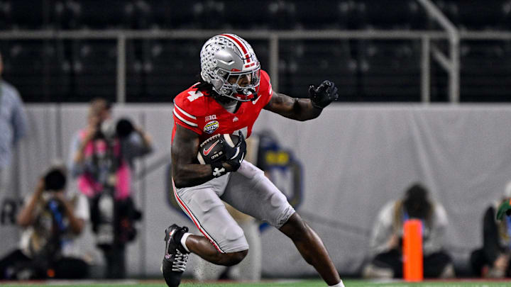 Dec 31, 2025; Arlington, TX, USA; Ohio State Buckeyes wide receiver Jeremiah Smith (4) runs with the ball during the 2025 Cotton Bowl and quarterfinal game of the College Football Playoff at AT&T Stadium. Mandatory Credit: Jerome Miron-Imagn Images