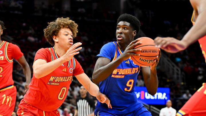 Apr 2, 2024; Houston, TX, USA; McDonald's All American East guard Drake Powell (9) drives to the basket around McDonald's All American West guard Trent Perry (0) during the first half at Toyota Center. Mandatory Credit: Maria Lysaker-USA TODAY Sports
