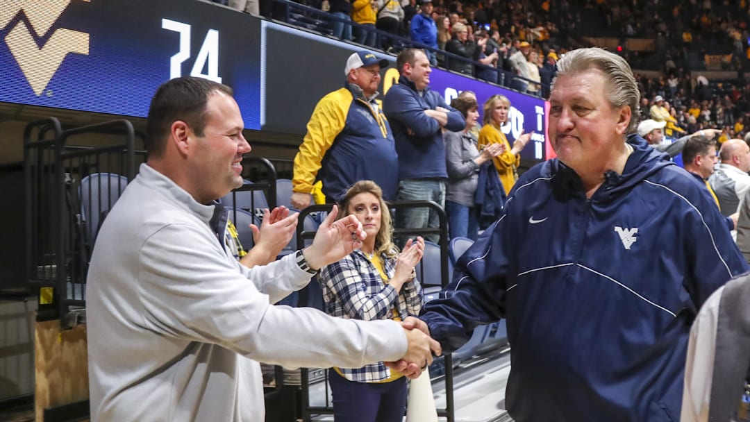 Jan 18, 2023; Morgantown, West Virginia, USA; West Virginia Mountaineers head coach Bob Huggins celebrates with West Virginia University Athletic Director Wren Baker after defeating the TCU Horned Frogs at WVU Coliseum. Mandatory Credit: Ben Queen-Imagn Images