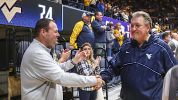Jan 18, 2023; Morgantown, West Virginia, USA; West Virginia Mountaineers head coach Bob Huggins celebrates with West Virginia University Athletic Director Wren Baker after defeating the TCU Horned Frogs at WVU Coliseum. Mandatory Credit: Ben Queen-Imagn Images
